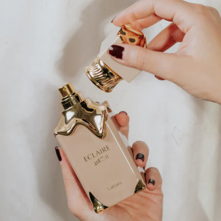 Elegant bottle of Eclaire Perfume 100ml Eau De Parfum by Lattafa, featuring a sleek, modern design with gold accents. Perfectly captures the luxury and allure of Arabian fragrances, ideal for any occasion.