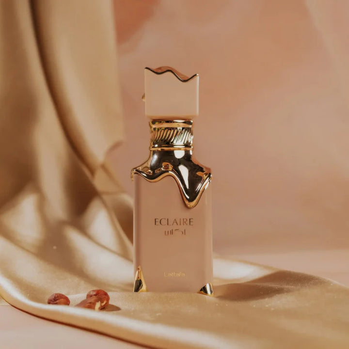 Elegant bottle of Eclaire Perfume 100ml Eau De Parfum by Lattafa, featuring a sleek, modern design with gold accents. Perfectly captures the luxury and allure of Arabian fragrances, ideal for any occasion.