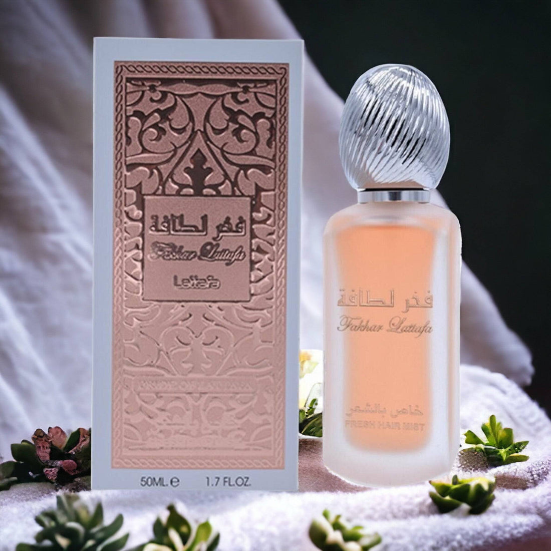 Fakhar Lattafa Fresh Hair Mist 50ml bottle surrounded by its scent notes of fruits, flowers, and warm vanilla.