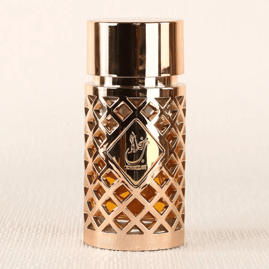 Elegantly designed bottle of Jazzab Gold women's perfume with fresh floral and woody notes.